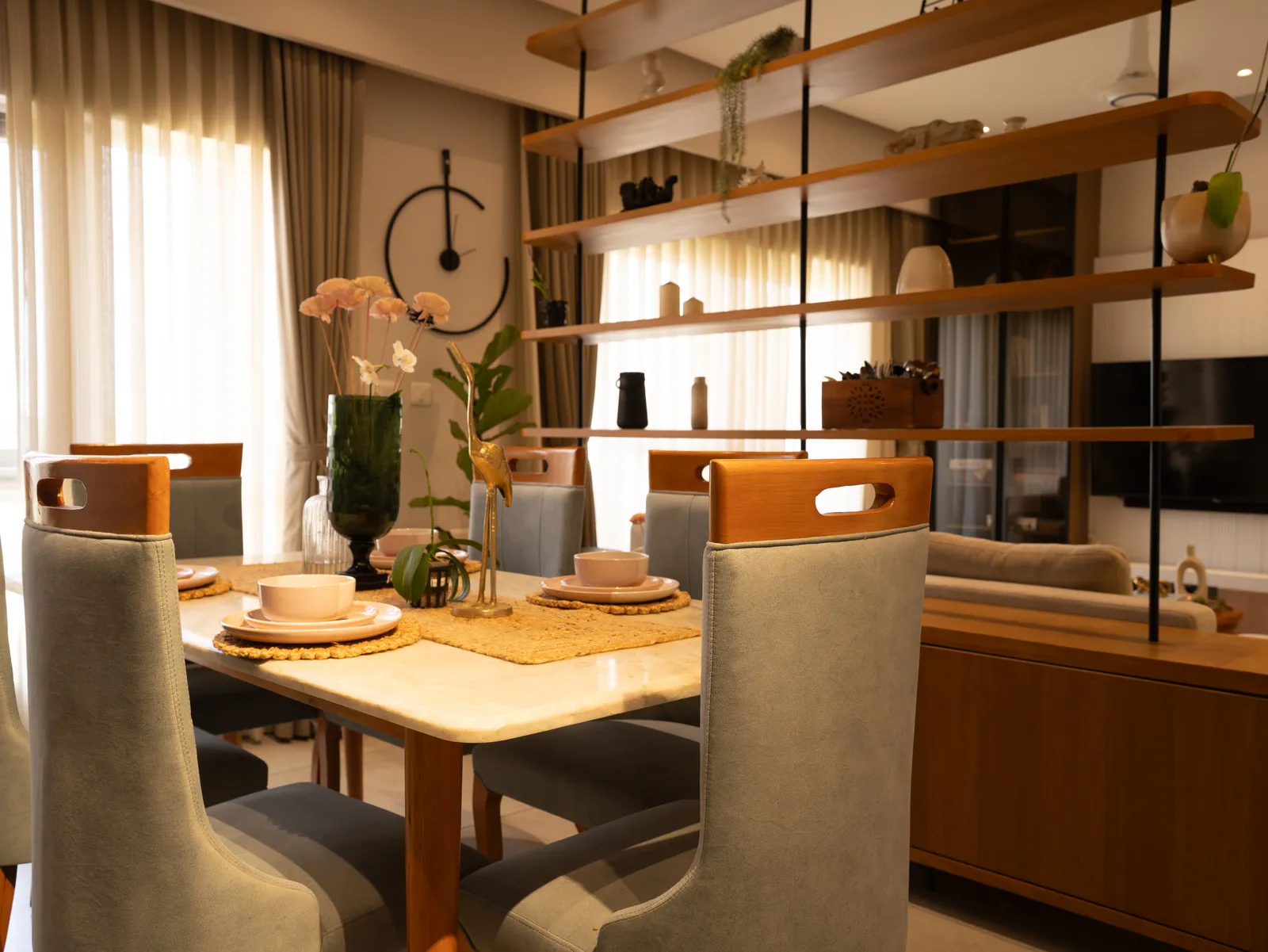 Dining table set beside the shelving partition — Amlan's Residence